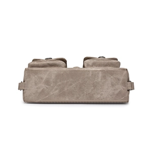 Detailed view of durable khaki canvas base and utility pockets with metal hardware
