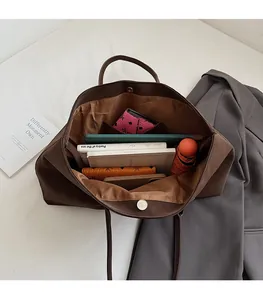 Spacious interior of a dark brown vintage tote bag showing large capacity for essentials