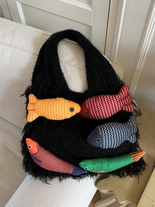 Large black plush knit tote bag featuring five colorful 3D fish shaped decorations