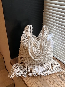 Handmade cream macramé tote bag with long fringe and lace detail for beach vacation