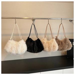 Plush faux fur shoulder bags in four colors displayed on a minimalist rack