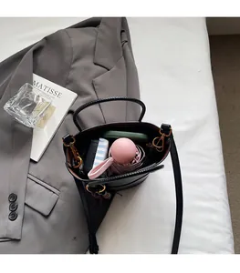 Interior view of black bucket bag showing spacious capacity for phone and umbrella