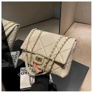 Detail of off-white quilted leather bag with gold metal twist lock and chain strap