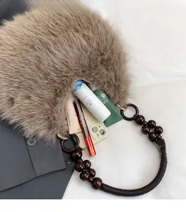 Detail of plush faux fur shoulder bag interior with large beads and spacious storage