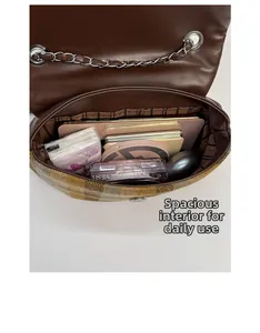 Detail view of the spacious inner compartment of the plaid saddle bag for daily essentials