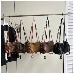 Detail of five faux suede and leopard print Boston bags with detachable straps