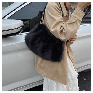 Close-up showing the soft texture and gloss of the black plush underarm pillow bag