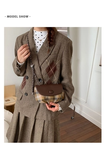 Retro plaid saddle bag with brown leather flap and chain strap worn with a tweed outfit