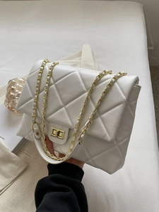White quilted crossbody bag with gold chain strap and turn-lock closure for women