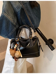 Black oil wax leather tote bag with white contrast stitching and cute bear charm