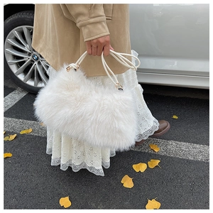 Detailed macro of white plush faux fur texture on a luxury autumn winter pillow handbag
