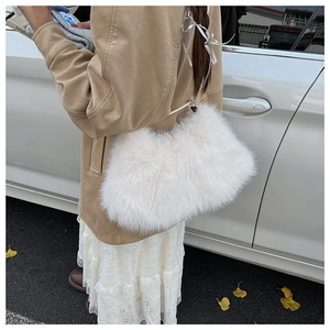 Detail view of high-quality white faux fur plush handbag with elegant metal buckle strap