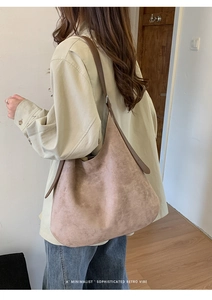 Close-up of the large dusty pink tote bag showing the minimalist design and wide shoulder strap