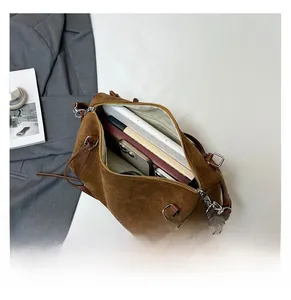 Spacious brown faux suede tote bag interior showing laptop and phone storage capacity