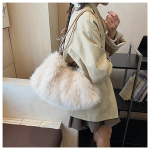Detailed close-up showing soft plush faux fur texture of the cream shoulder bag