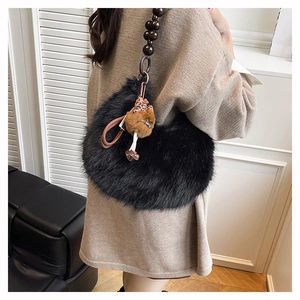 Detail view of plush black faux fur shoulder bag with large dark brown beaded strap
