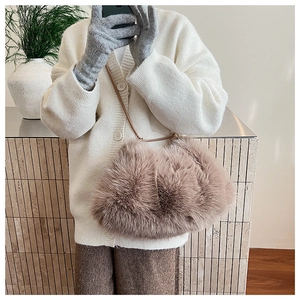 Close-up of fluffy faux fur plush shoulder bag with minimalist strap for winter