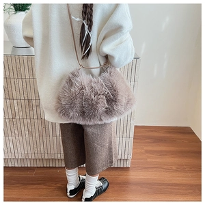 Plush faux fur shoulder bag in taupe with leather strap styled for autumn outfit