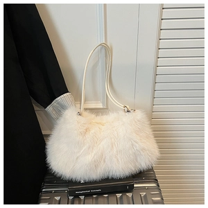 Detailed close-up of fluffy white faux fur tote bag with slim shoulder straps on a suitcase