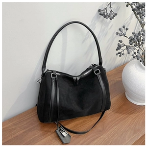 Detailed view of black suede tote bag with leather straps and silver hardware accents
