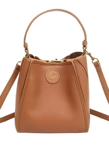 Brown litchi leather bucket bag with top handle and gold hardware in minimalist style