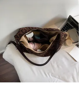 Detailed interior of leopard print tote bag showing large capacity and internal pockets