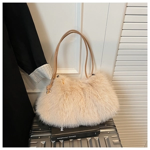 Detail of plush faux fur handbag with leather handles on a suitcase in a minimal setting