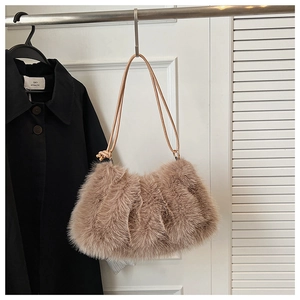 Detailed macro of plush faux fur shoulder bag with soft texture and leather strap detail