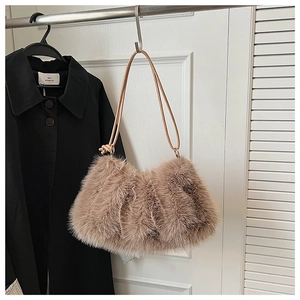 Detail of plush khaki faux fur shoulder bag with slender leather strap and knot accent
