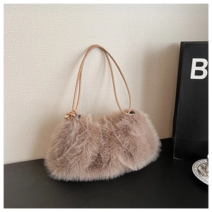 Detail of fluffy faux fur tote bag with stylish long synthetic leather knotted handles