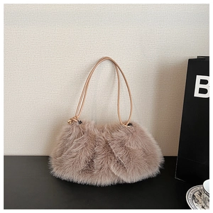 Detailed macro view of soft faux fur texture and leather straps on the dusty pink bag