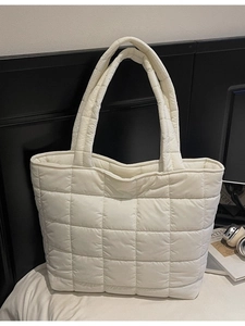 Minimalist white quilted puffer tote bag with stitched grid pattern and soft handles