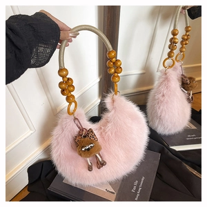 Pink plush crescent handbag featuring wooden bead handles and a cute bear charm detail