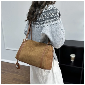 Brown suede tote bag shown on a model featuring a vintage Boston silhouette and silver lock
