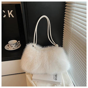 Detail of soft white faux fur plush bag with long handles in an elegant minimalist scene