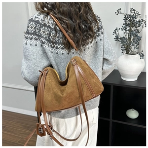 Detailed view of the brown suede tote bag with silver padlock and leather straps