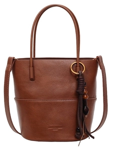 Brown textured leather bucket bag with stitching details and detachable crossbody strap