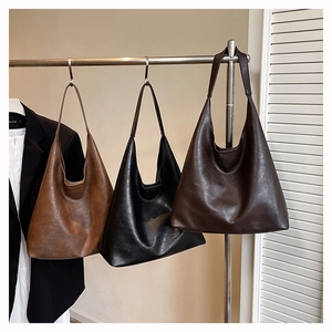 Three large Hobo tote bags in brown, black, and coffee showing soft PU leather texture