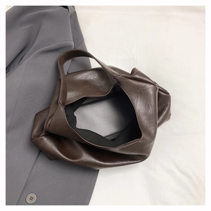 Detail of the high-quality dark brown faux leather texture and large opening on the tote bag