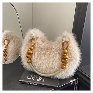 Detail of light camel faux fur bag with unique wooden bead and gold woven handle