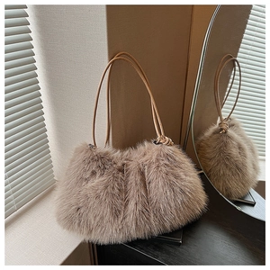 Detailed view of the soft faux fur texture and leather straps of a plush pillow handbag
