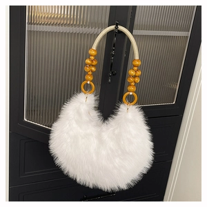 Detail of white fluffy faux fur bag with beaded wooden handle and woven rope strap