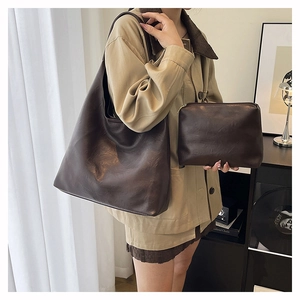 Detailed set of dark brown vintage tote bag and matching coin purse with faux leather texture