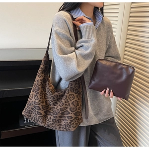 Detail of leopard print canvas tote bag with brown leather pouch for everyday storage