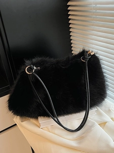 Chic black plush faux fur pillow bag with golden hardware and slender shoulder strap