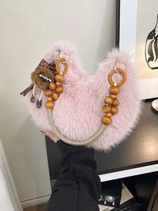 Fuzzy pink crescent faux fur handbag with wooden bead handle and sloth charm