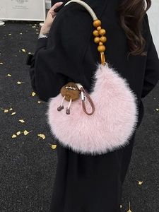 Pink faux fur crescent shoulder bag with wooden bead handle and cartoon plush charm