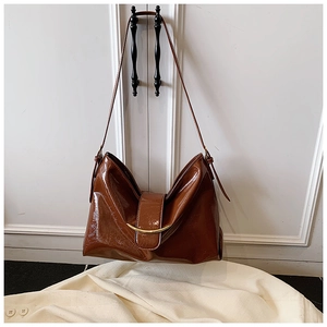Détail du cabas marron vintage en cuir verni brillant et fermoir en métal doré