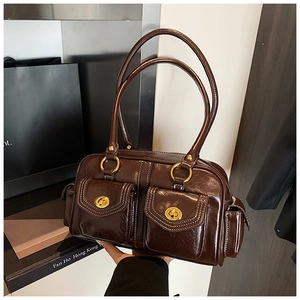 Detail view of brown vintage Boston bag showing double front pockets and contrast stitching