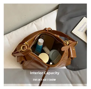Detail view of large brown vintage tote bag showing spacious inner capacity for essentials